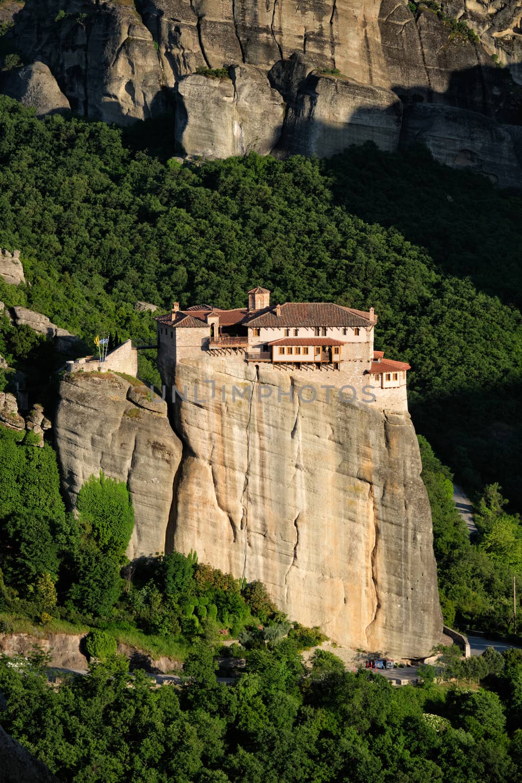 Monastery of Rousanou perched on a cliff in famous greek tourist destination Meteora in Greece on sunset with scenic landscape