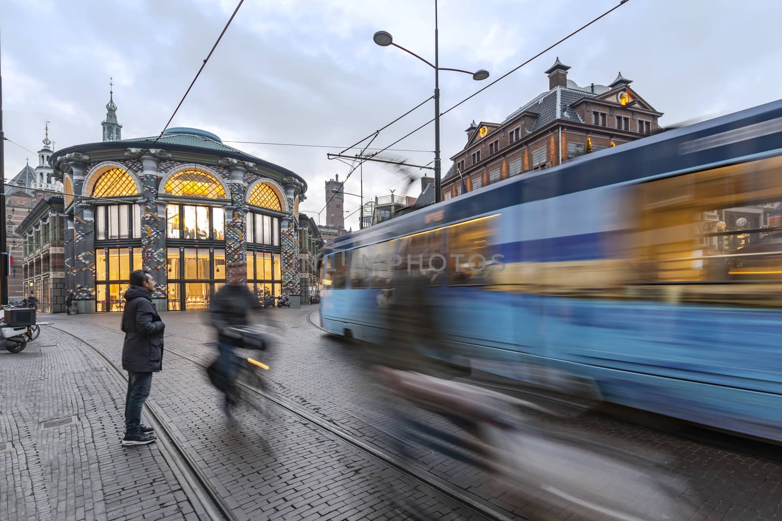 Fast tram and cyclist in The Hague, Netherlands
