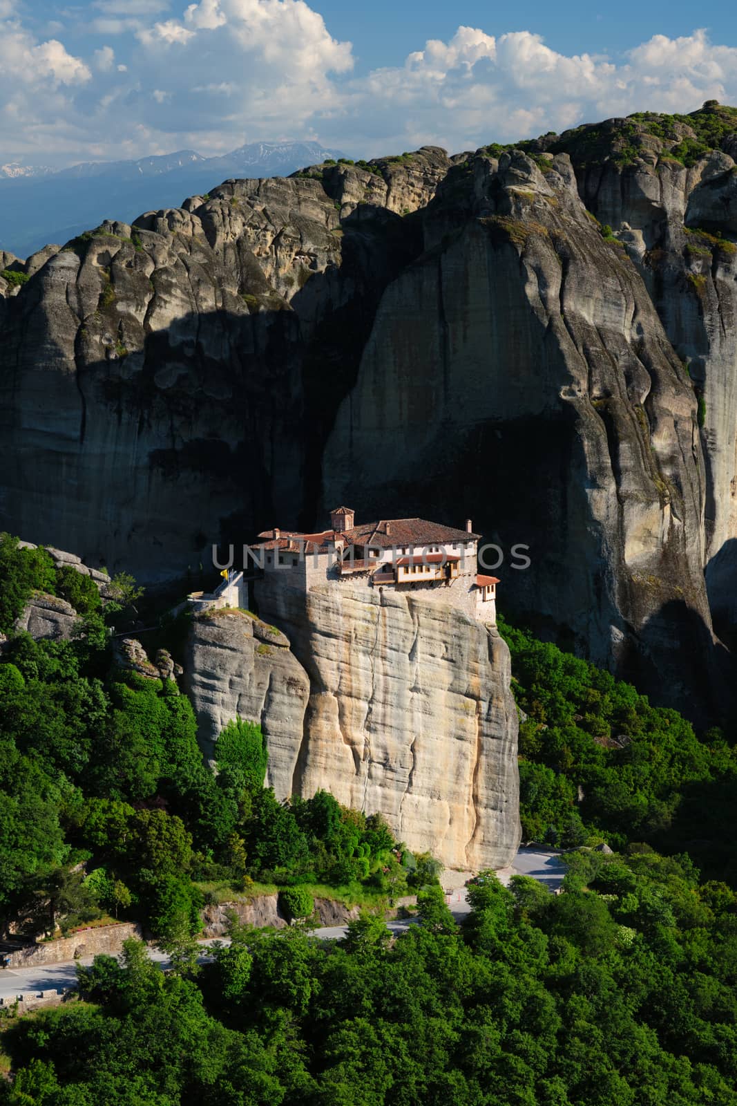 Monastery of Rousanou perched on a cliff in famous greek tourist destination Meteora in Greece on sunset with scenic landscape