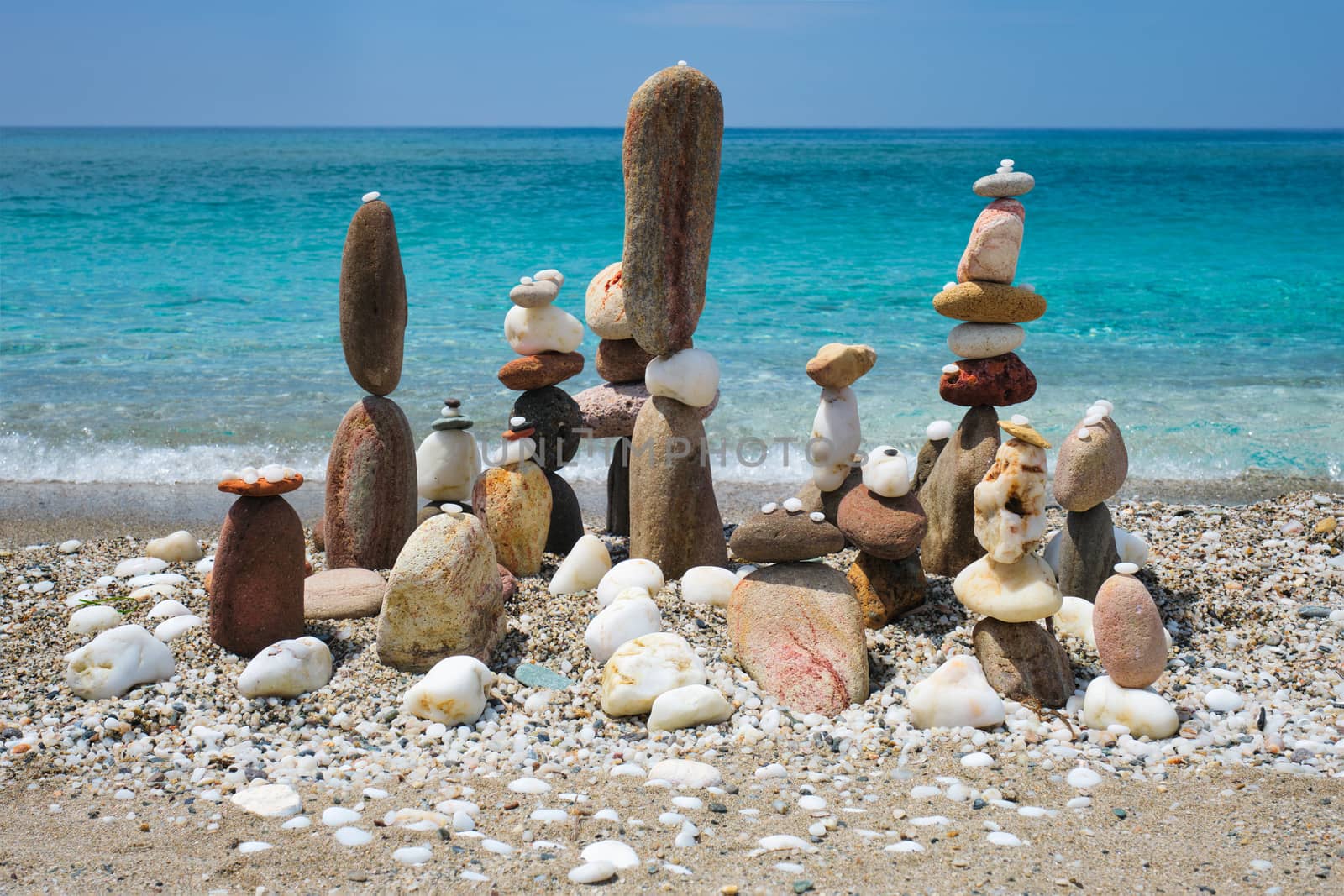 Concept of balance and harmony - pebble stone stacks on the beach by dimol