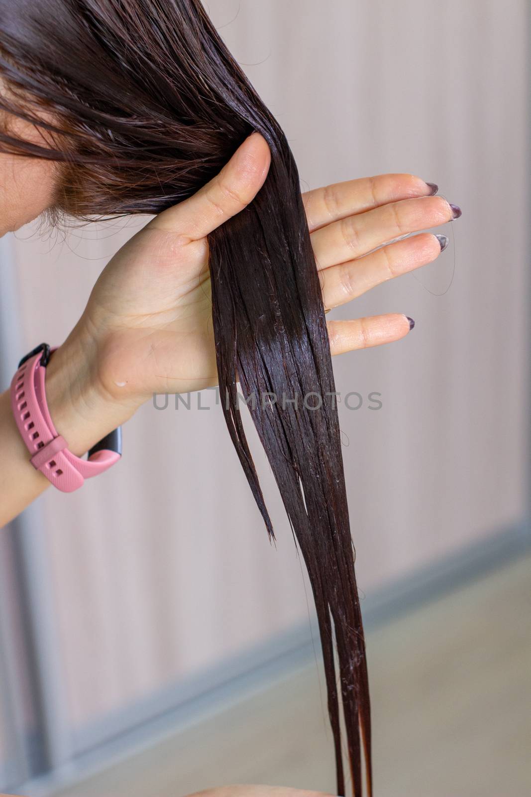 Women's hair. chestnut color. Woman washes her hair.