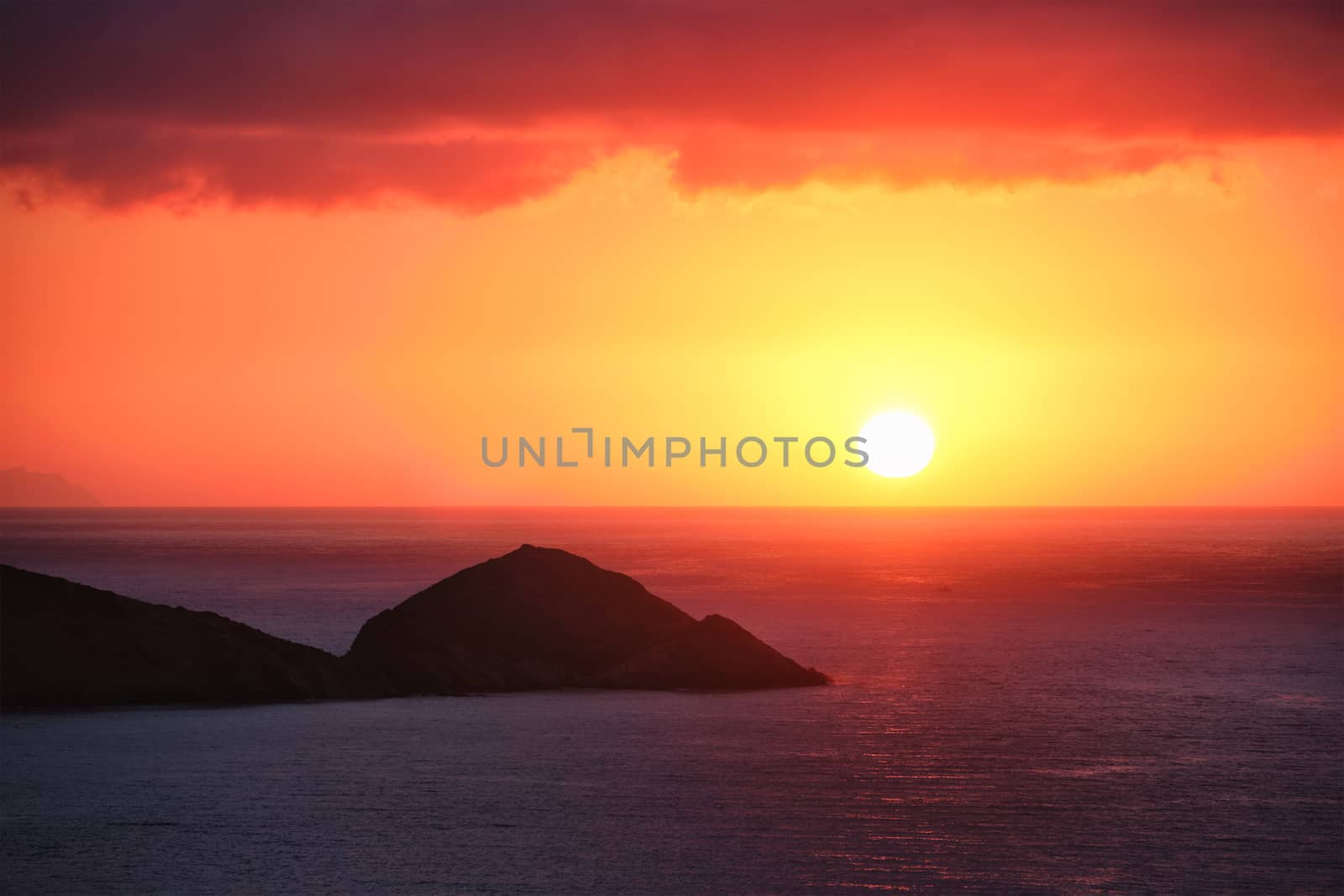 Sea sunset. Seascape sunset with island. Sun setting down in sea. Crete island, Greece