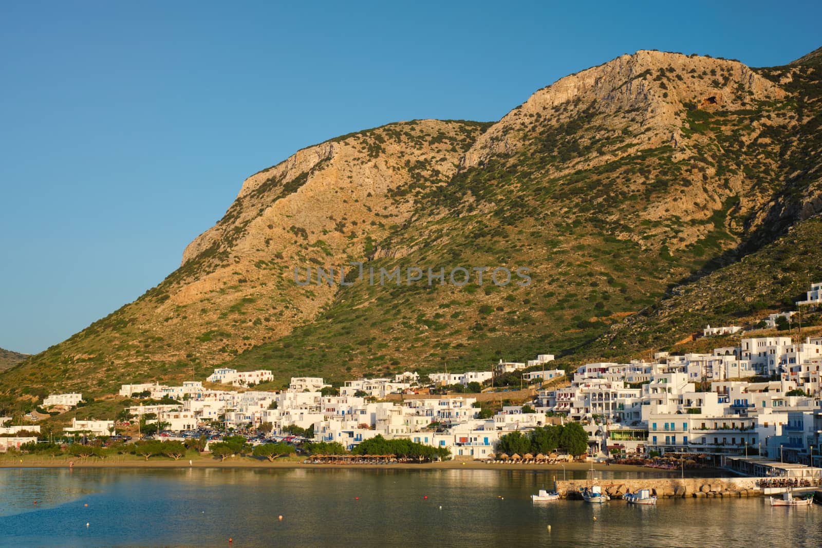 Kamares town with traditional white houses on Sifnos island on sunset. Greece by dimol