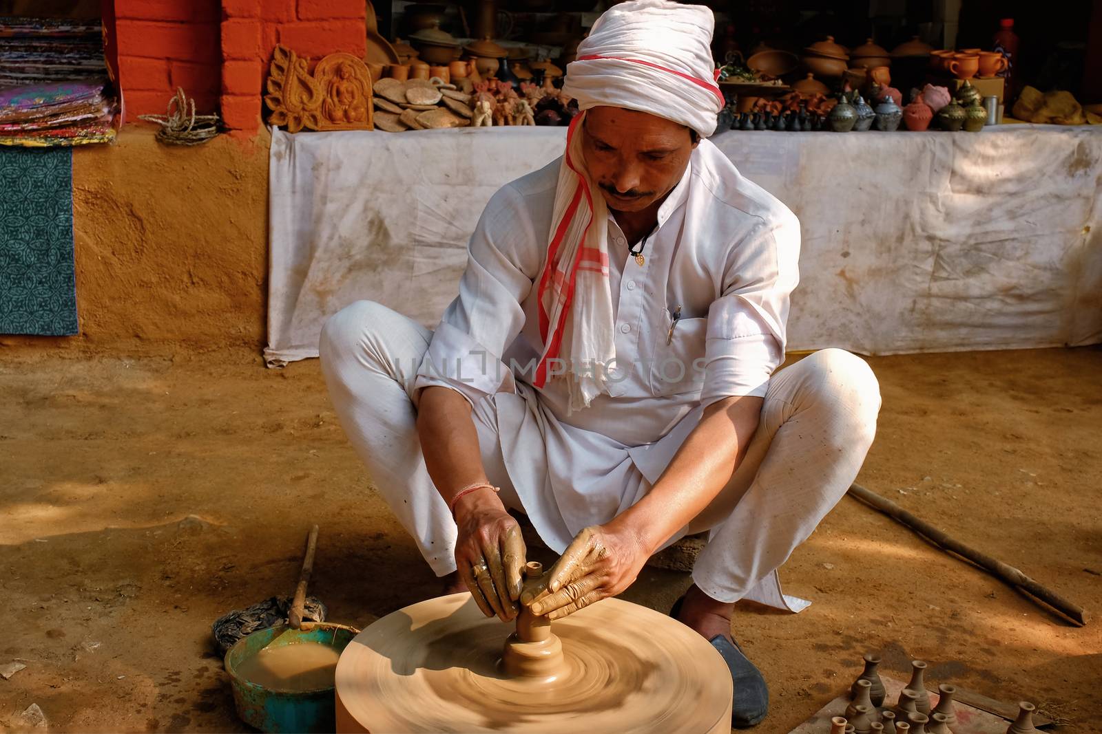 Indian potter at work, Shilpagram, Udaipur, Rajasthan, India by dimol