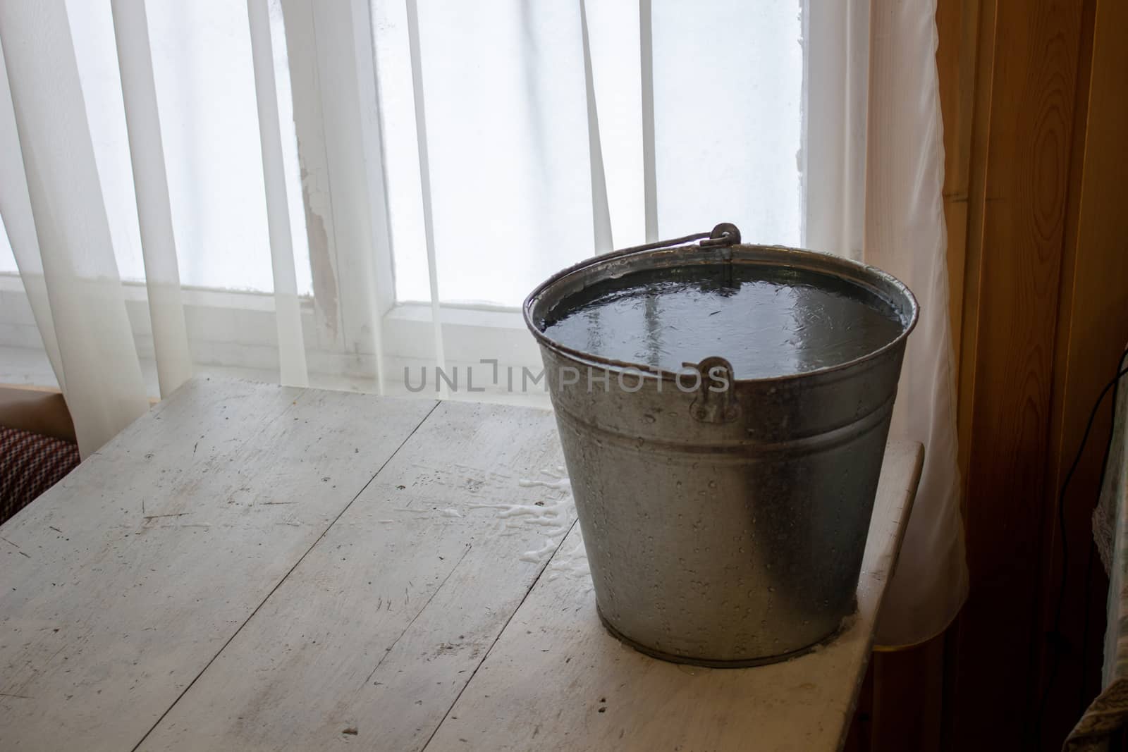 Bucket of water on the table in the cold. Close-up of an ice bucket on the background