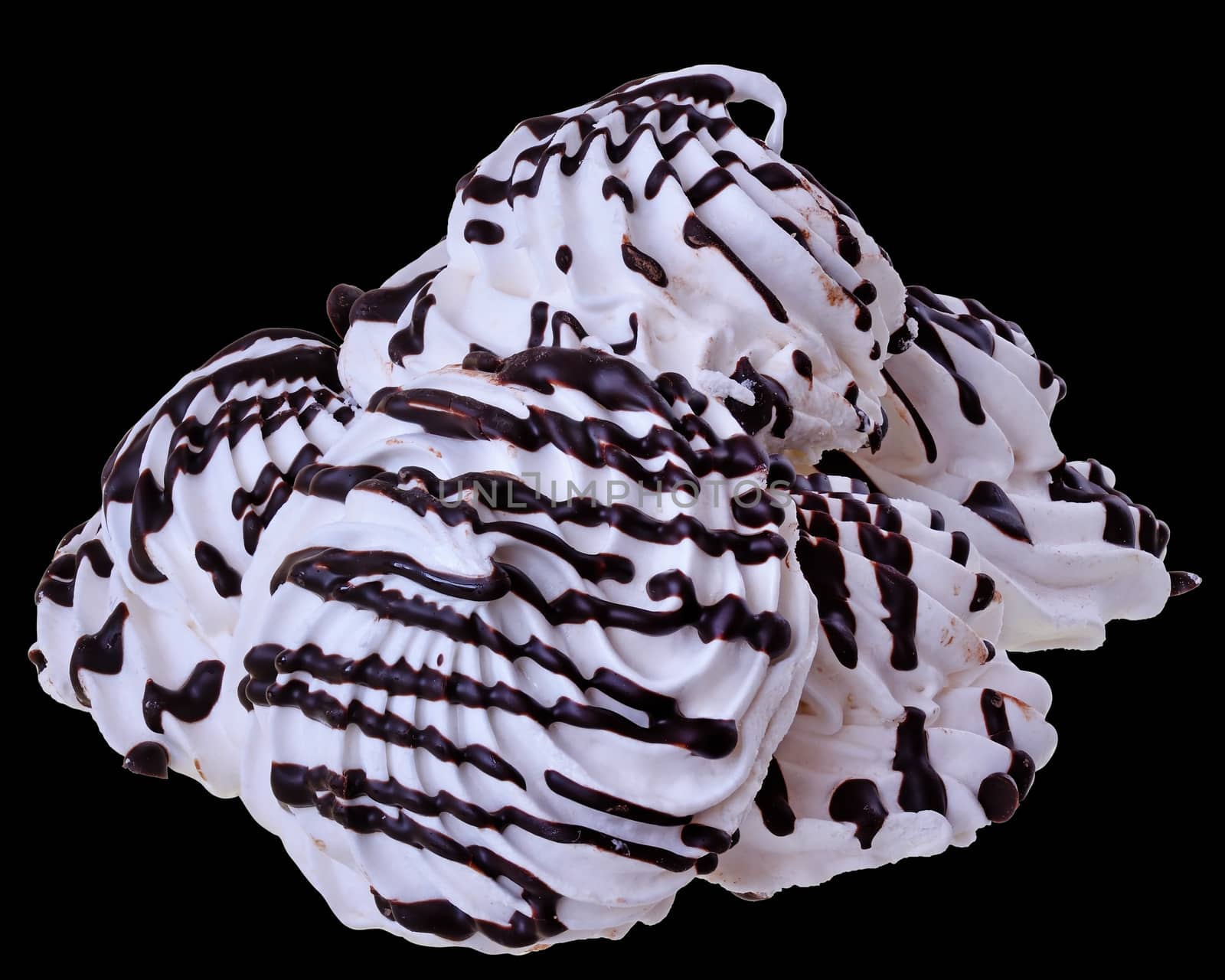 Meringue with chocolate closeup isolated on black background.