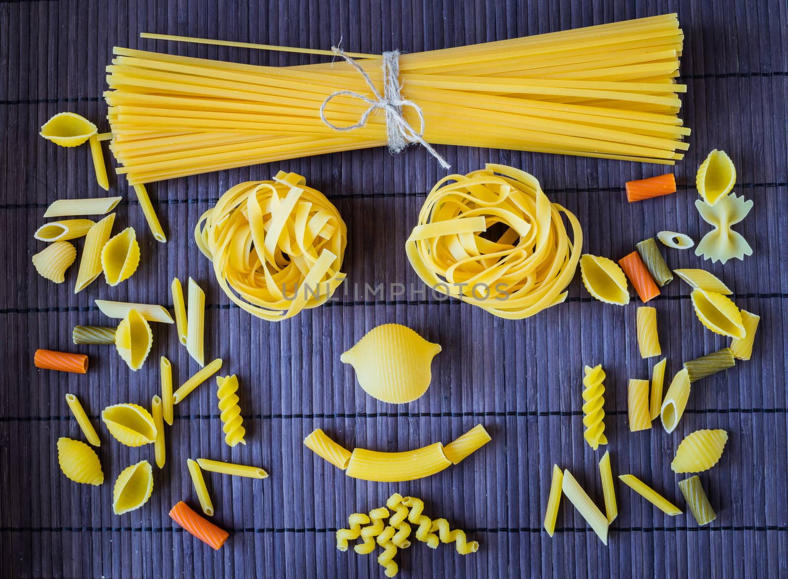 Set of pasta of various types of close-up on a bamboo napkin.