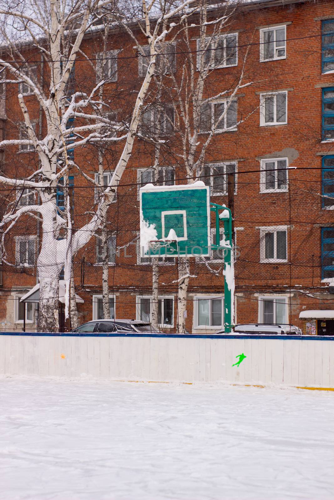 Basketball ring in winter on ice. Ice rink by AnatoliiFoto