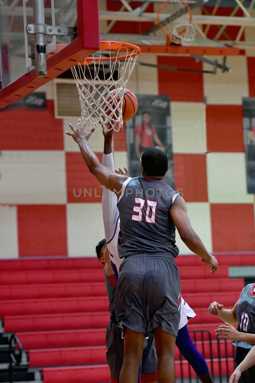 Young athletes making great basketball plays during a game. Slam Dunks and layups