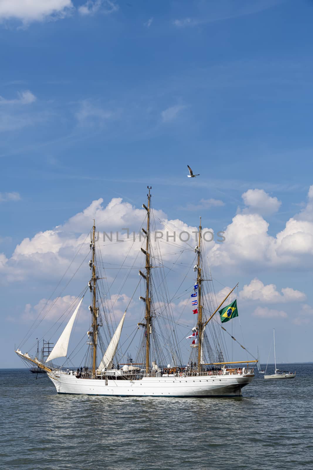 Antique tall ship, vessel leaving the harbor of The Hague, Scheveningen under a sunny and blue sky by ankorlight