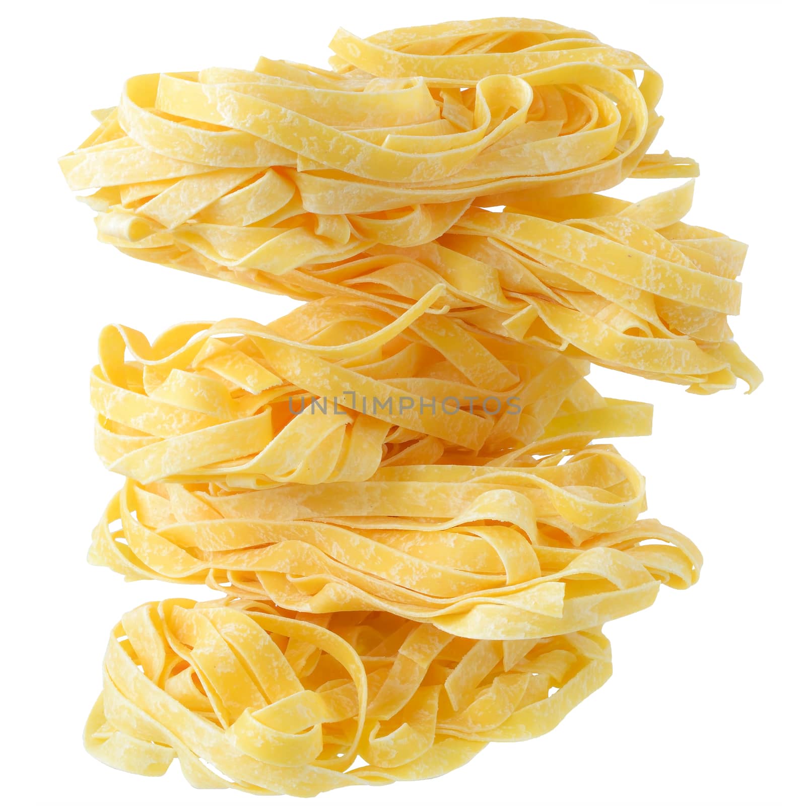 Fettuccine pasta nests close up on a isolated white background.