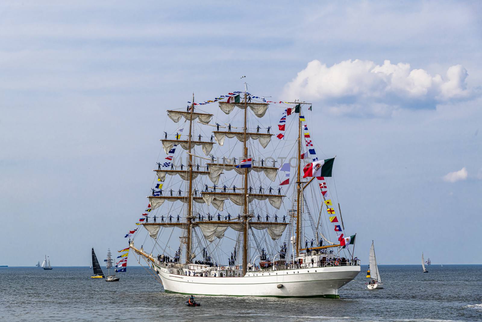 Antique tall ship, vessel leaving the harbor of The Hague, Scheveningen under a sunny and blue sky by ankorlight