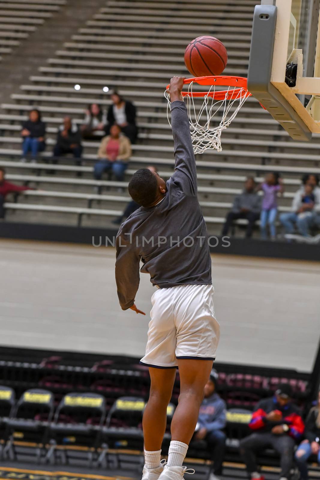 Young athletes making great basketball plays during a game. Slam Dunks and layups