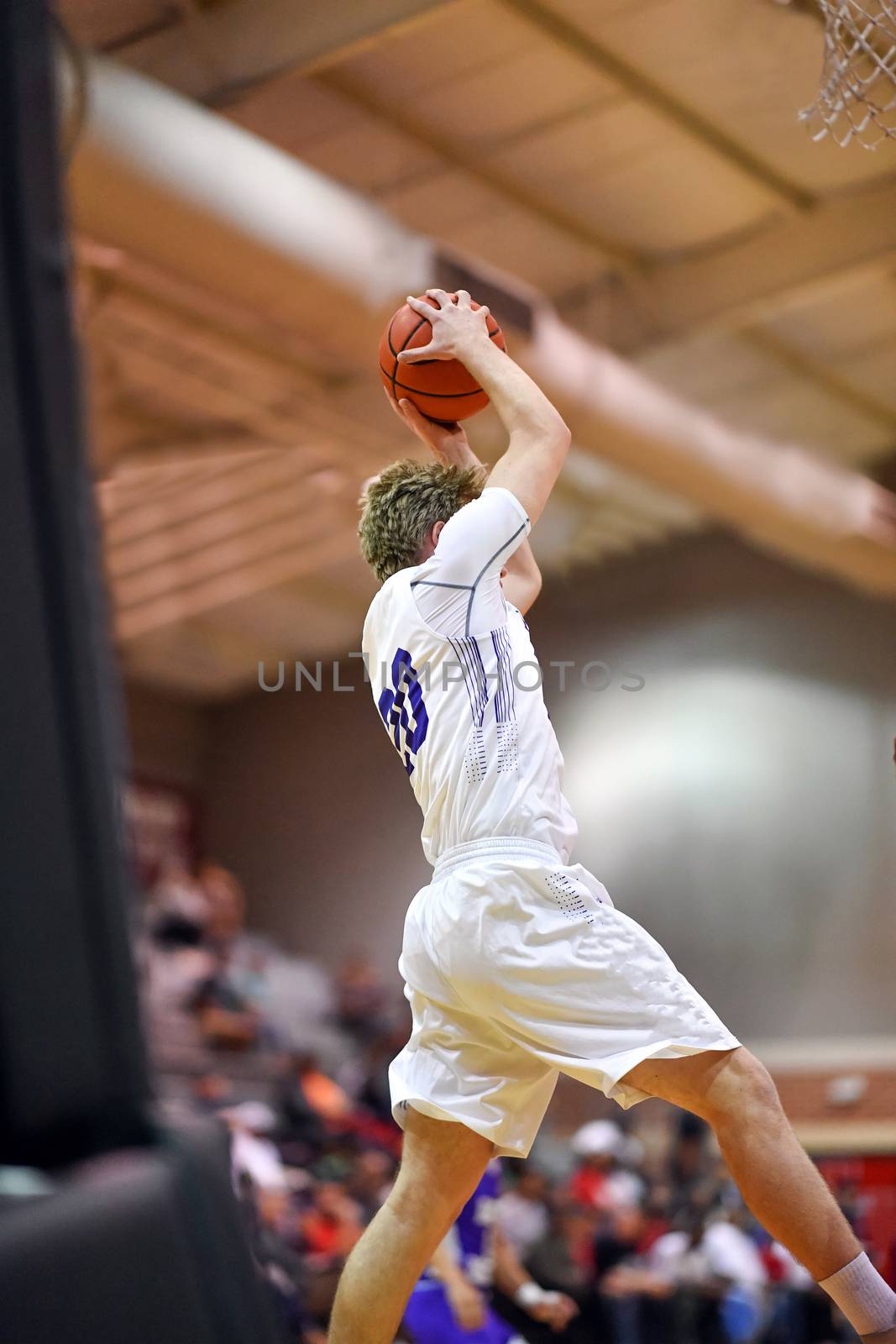 Young athletes making great basketball plays during a game. Slam Dunks and layups