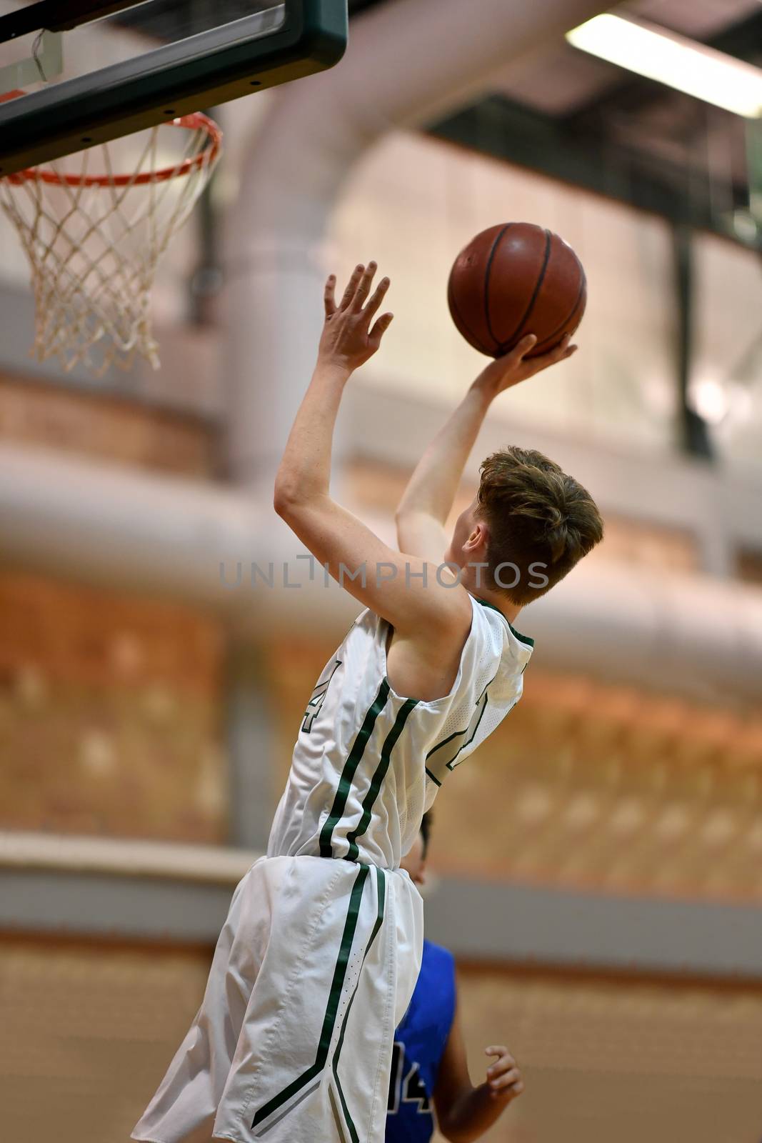 Young athletes making great basketball plays during a game. Slam Dunks and layups