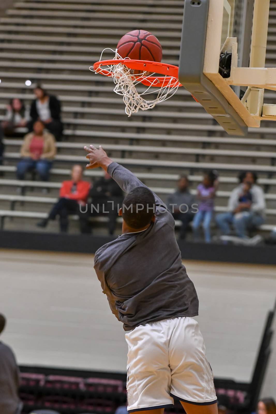 Young athletes making great basketball plays during a game. Slam Dunks and layups