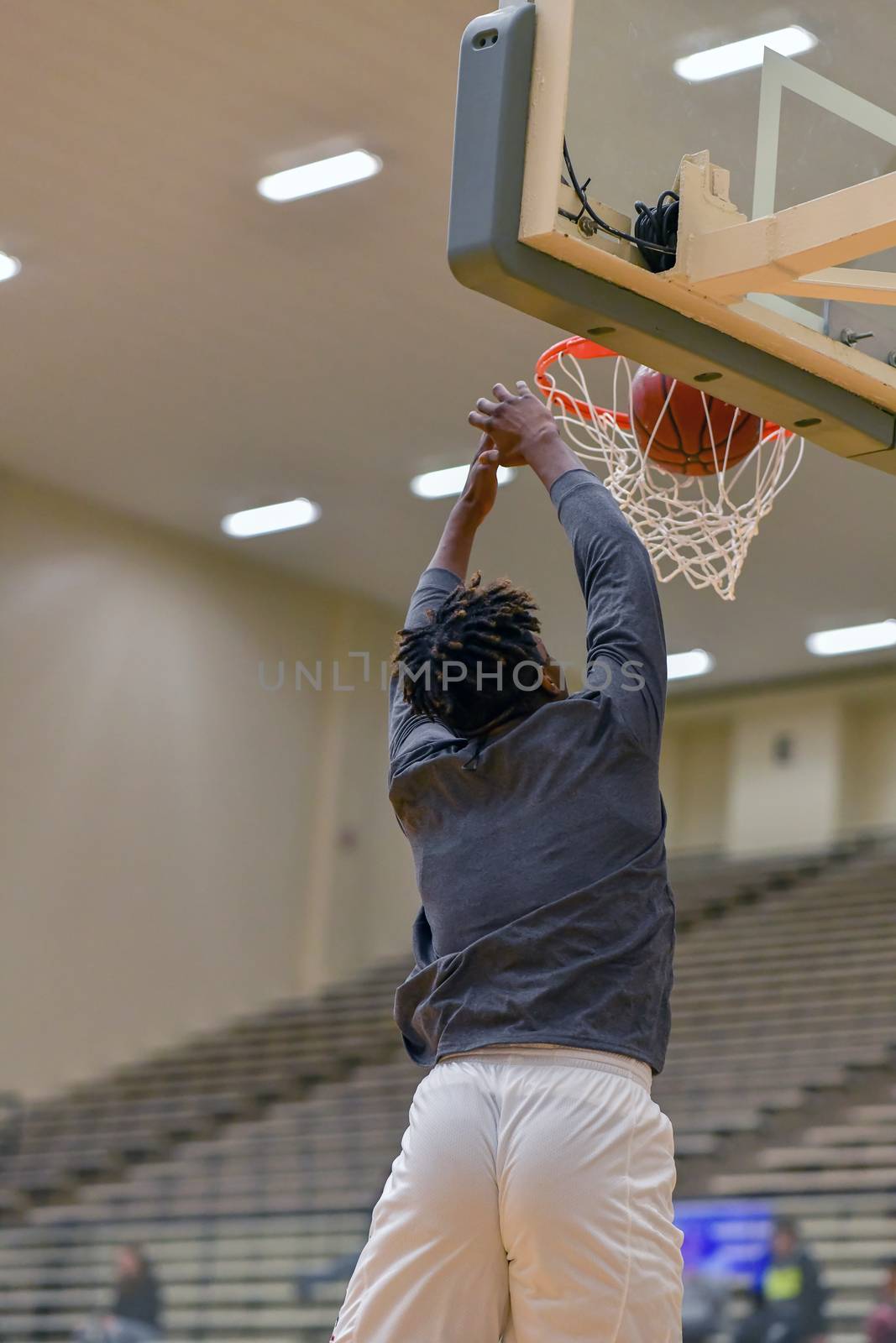 Young athletes making great basketball plays during a game. Slam Dunks and layups