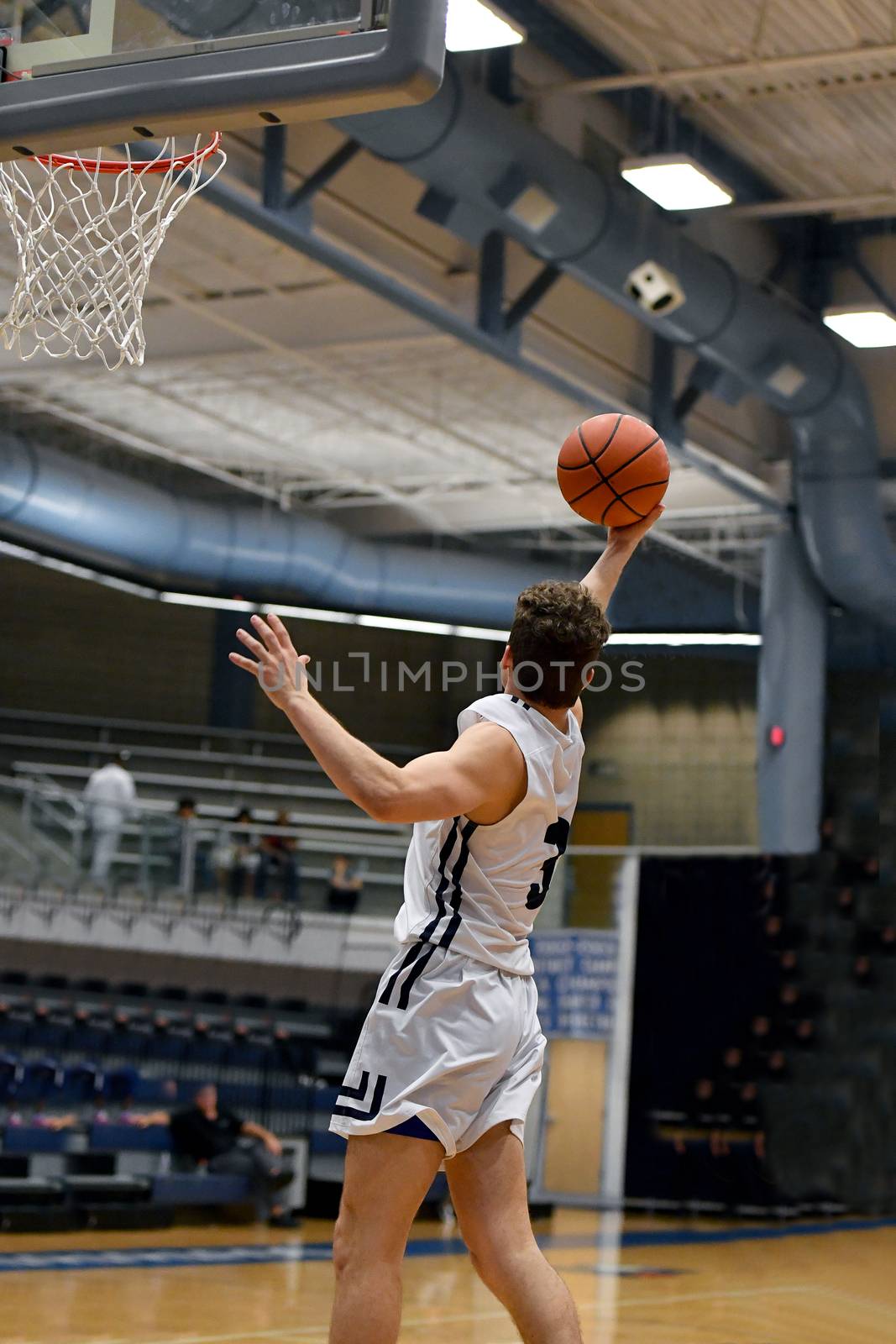 Young athletes making great basketball plays during a game. Slam Dunks and layups