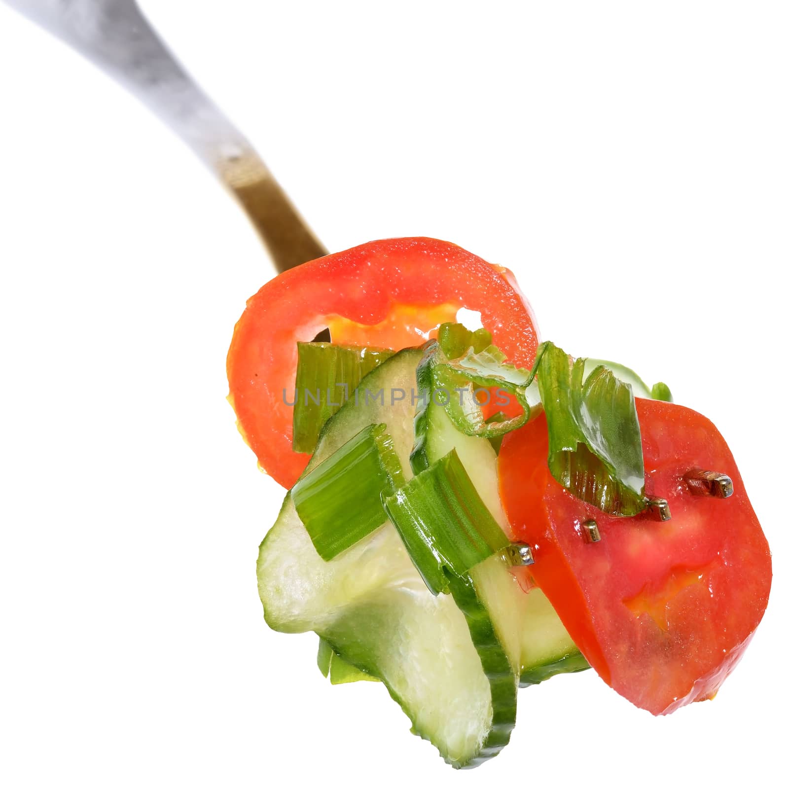 Fork with salad vegetables from tomato and cucumber isolated on a white background