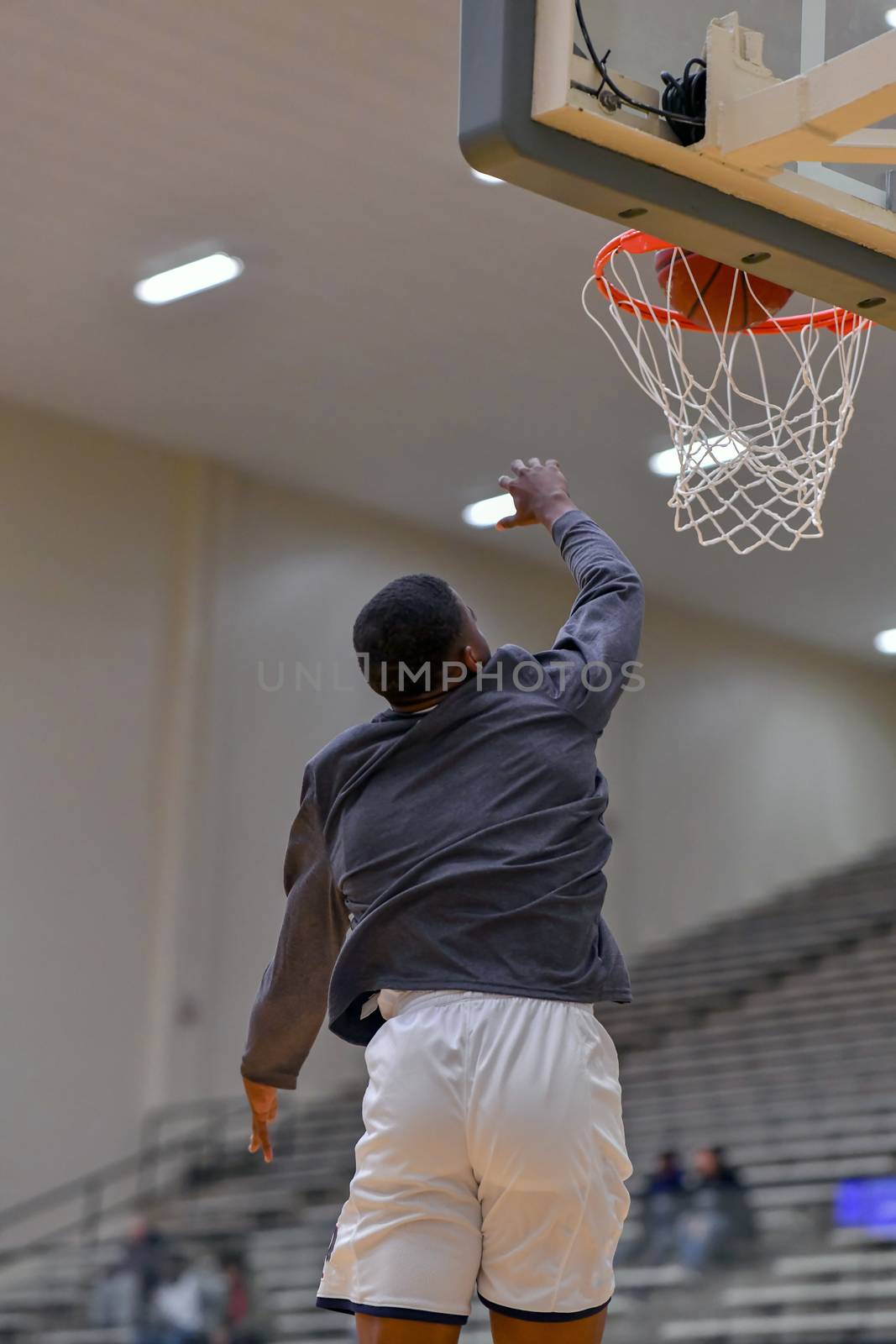 Young athletes making great basketball plays during a game. Slam Dunks and layups