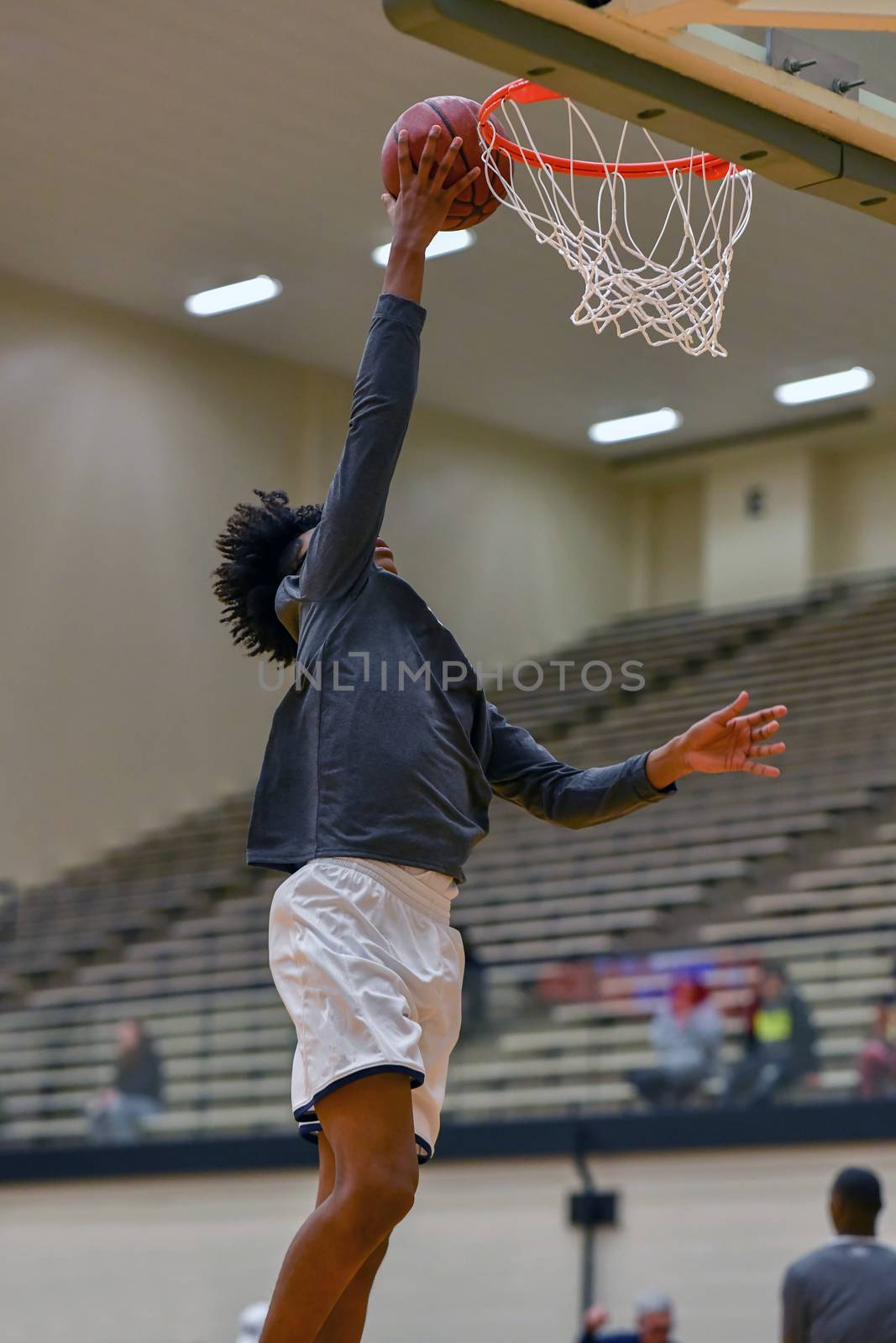 Young athletes making great basketball plays during a game. Slam Dunks and layups