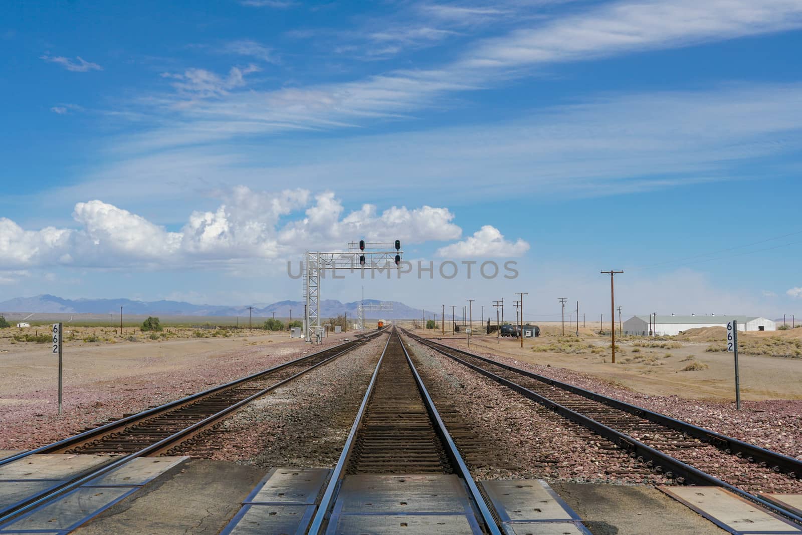 Railroad crossing gates on a road in the Mojave Desert in the Southwestern United States. California.