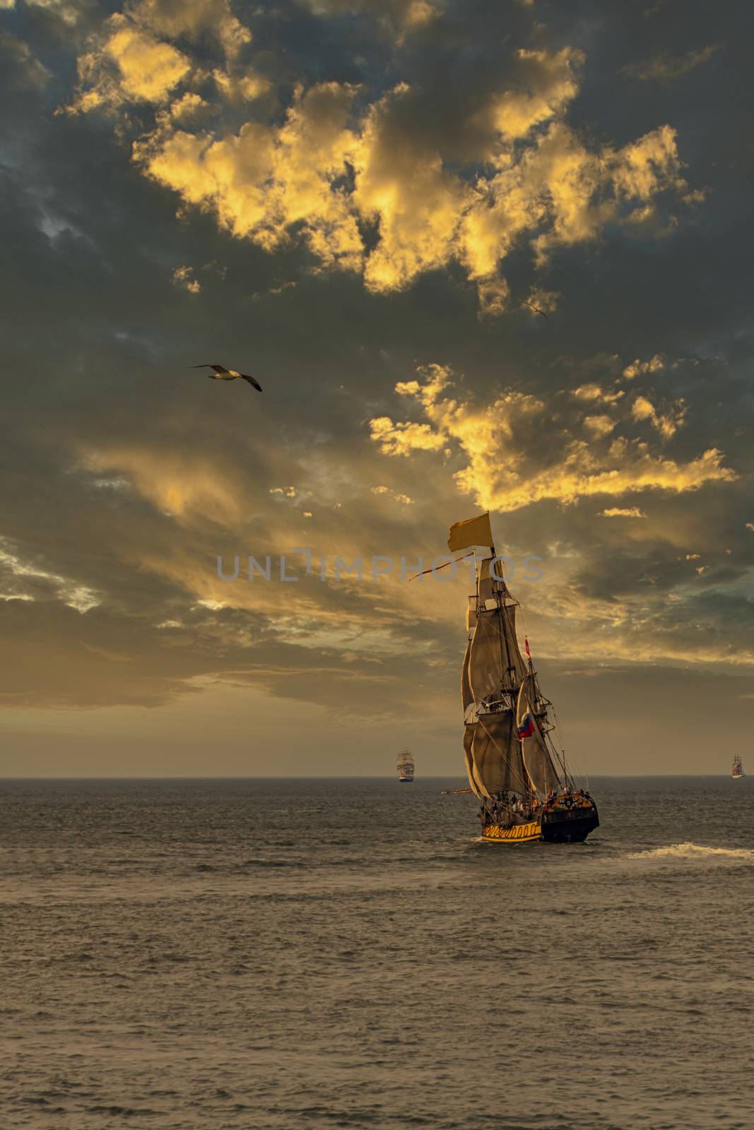 Antique tall ship, vessel leaving the harbor of The Hague, Scheveningen under a sunny and blue sky