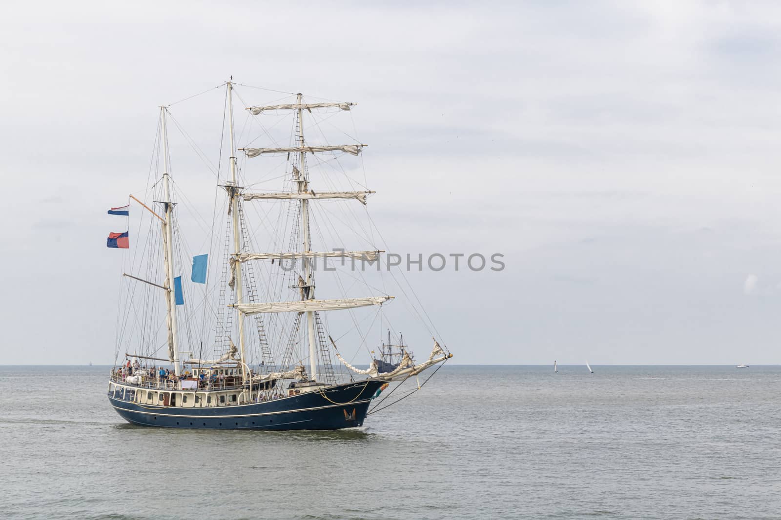 Antique tall ship, vessel entering the harbor of The Hague, Scheveningen under a sunny and blue sky by ankorlight