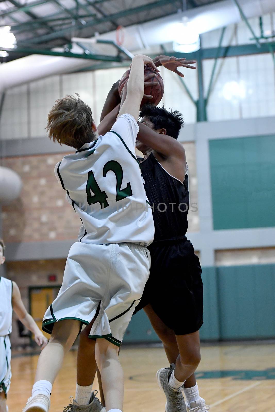 Young athletes making great basketball plays during a game. Slam Dunks and layups