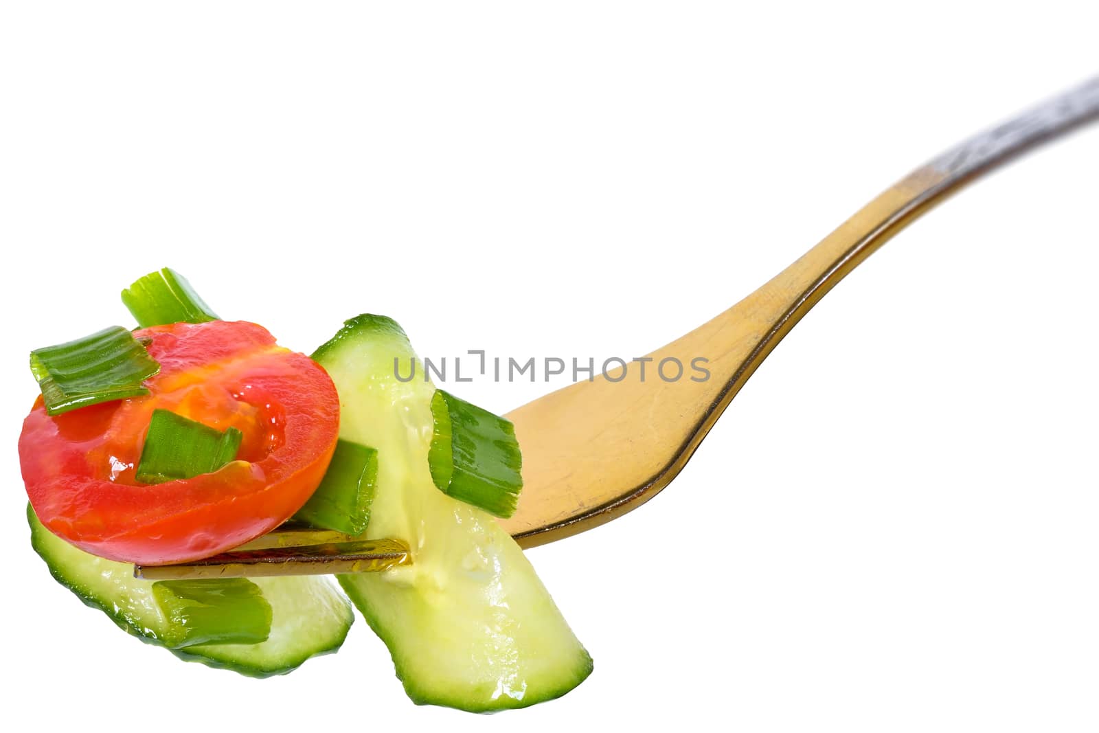 Fork with salad vegetables from tomato and cucumber isolated on a white background