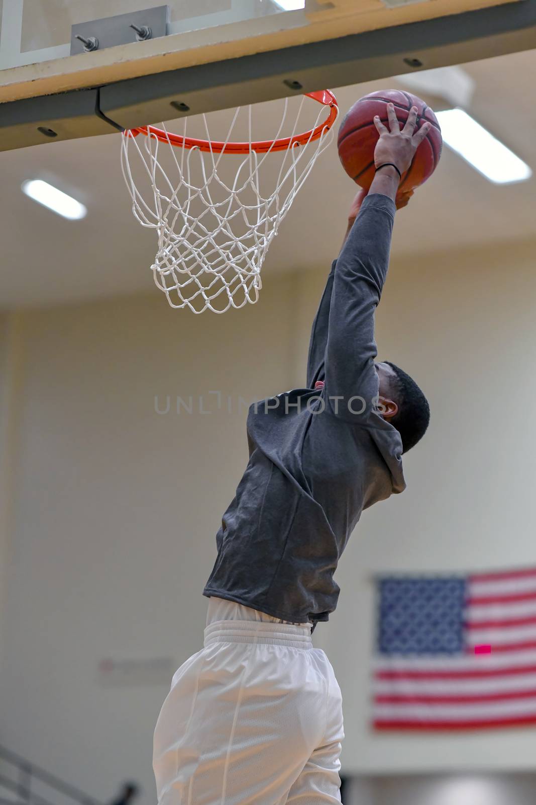 Young athletes making great basketball plays during a game. Slam Dunks and layups