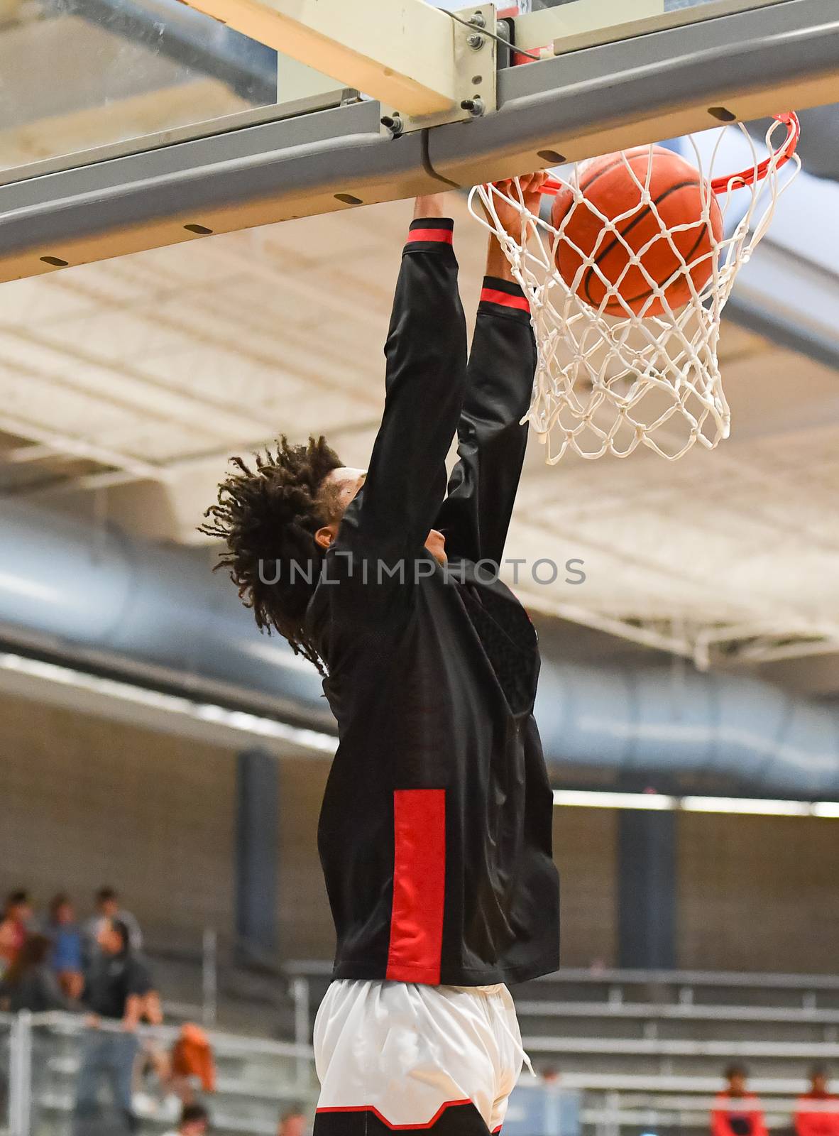 Young athletes making great basketball plays during a game. Slam Dunks and layups