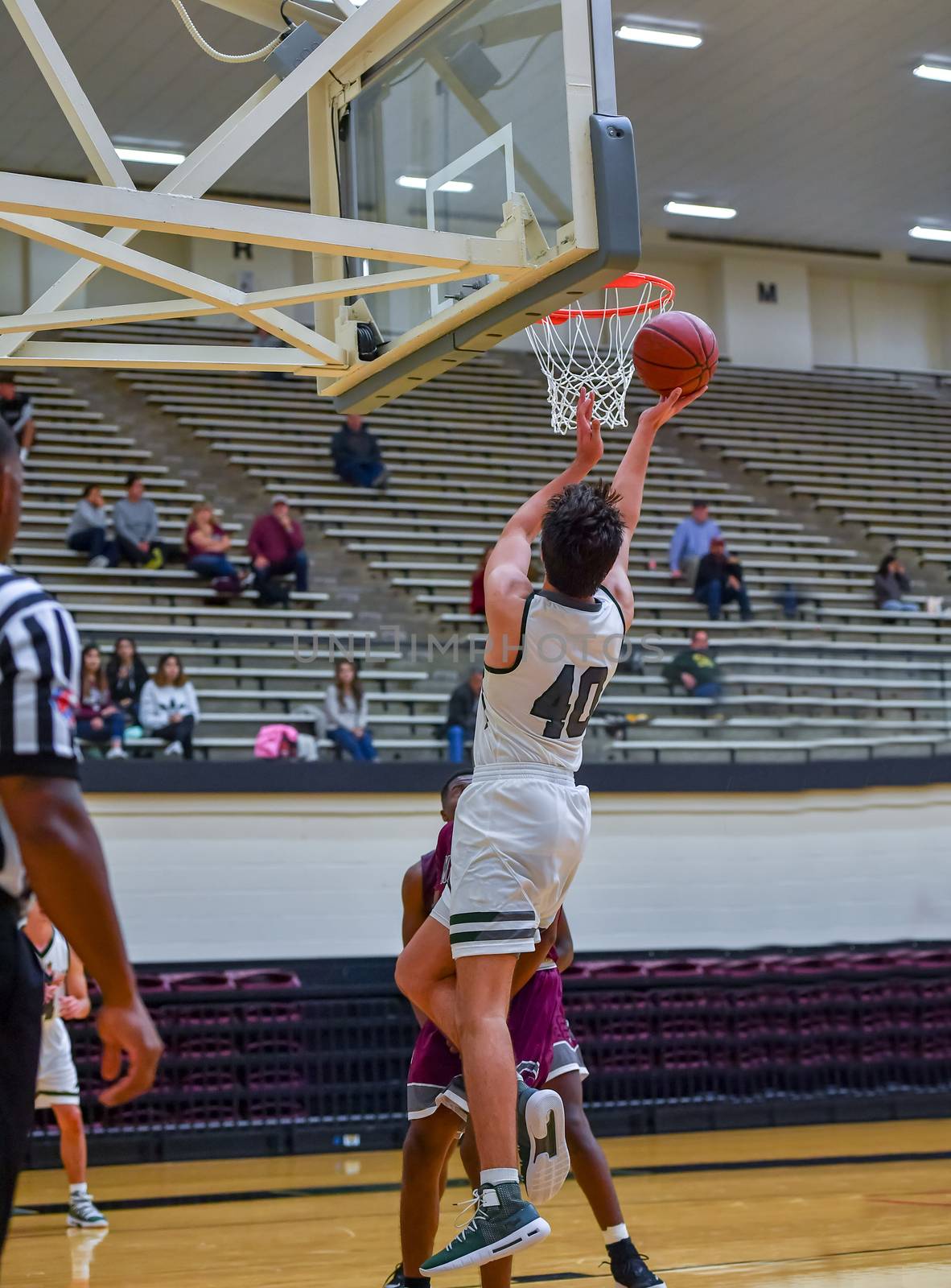 Young athletes making great basketball plays during a game. Slam Dunks and layups