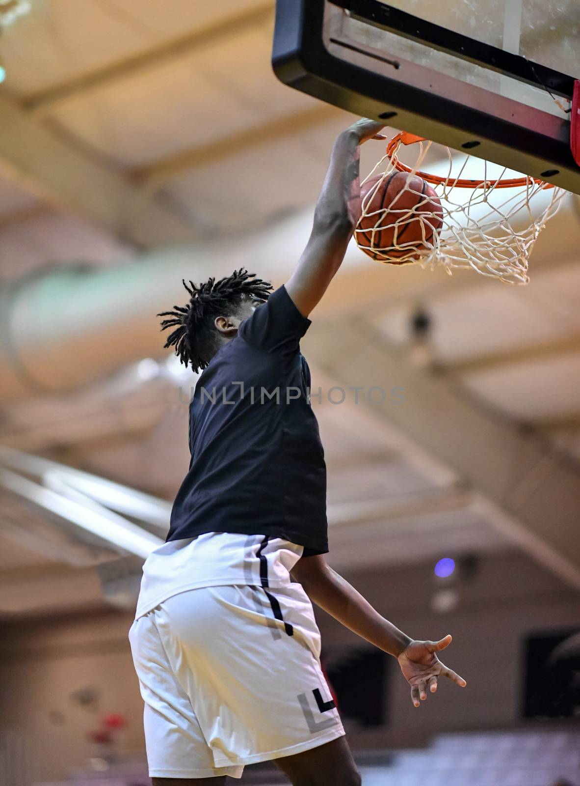 Young athletes making great slam dunks and lay ups during a basketball game