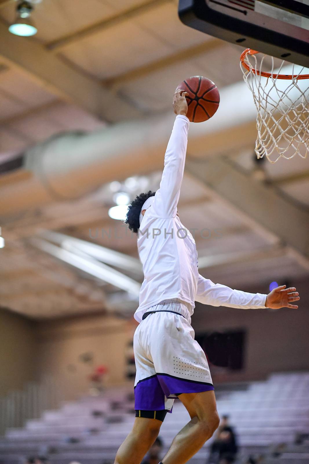 Young athletes making great slam dunks and lay ups during a basketball game