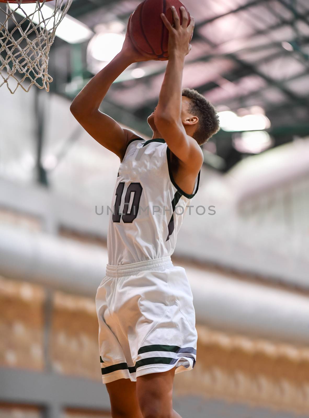 Young athletes making great basketball plays during a game. Slam Dunks and layups