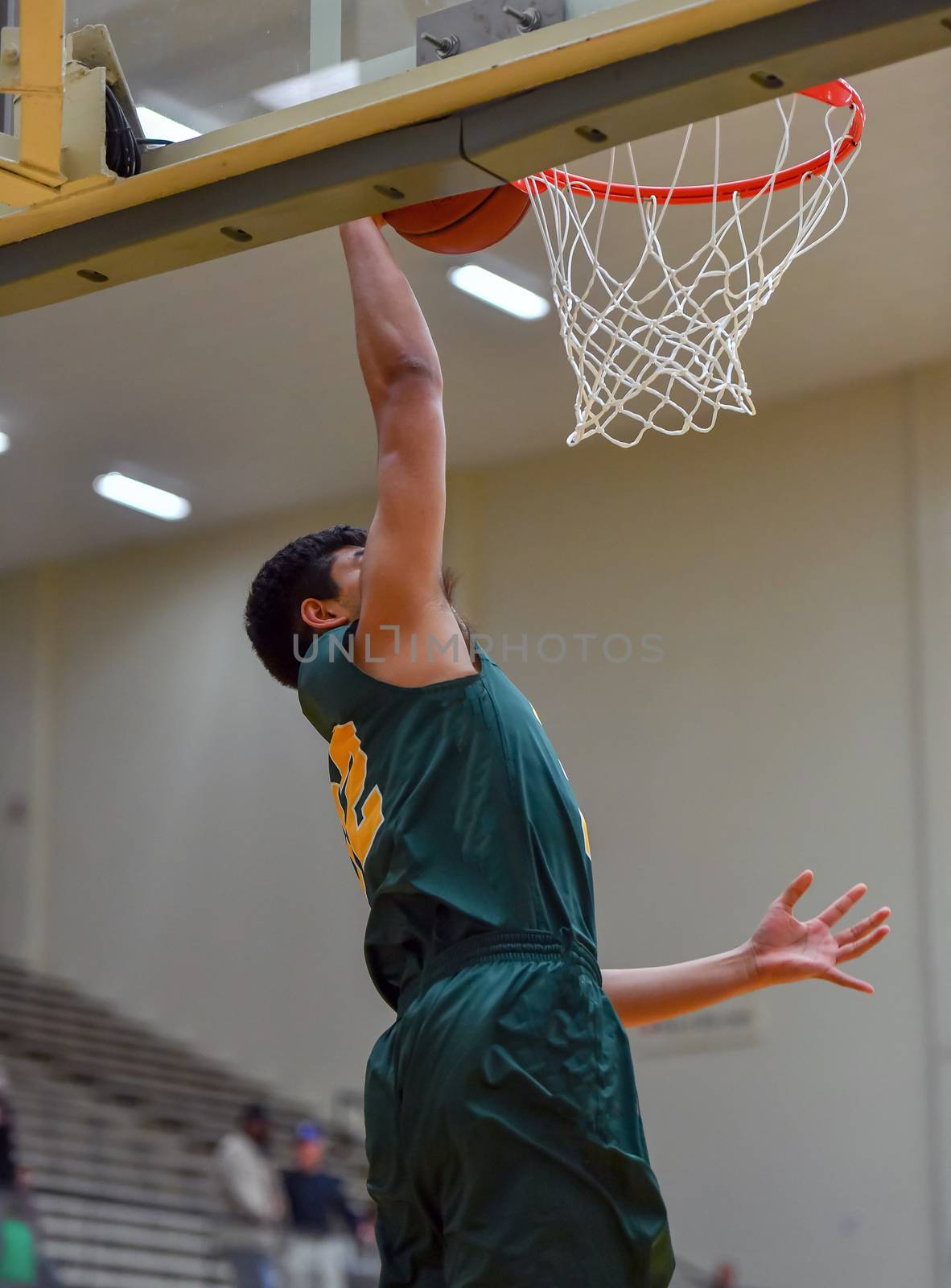 Young athletes making great basketball plays during a game. Slam Dunks and layups