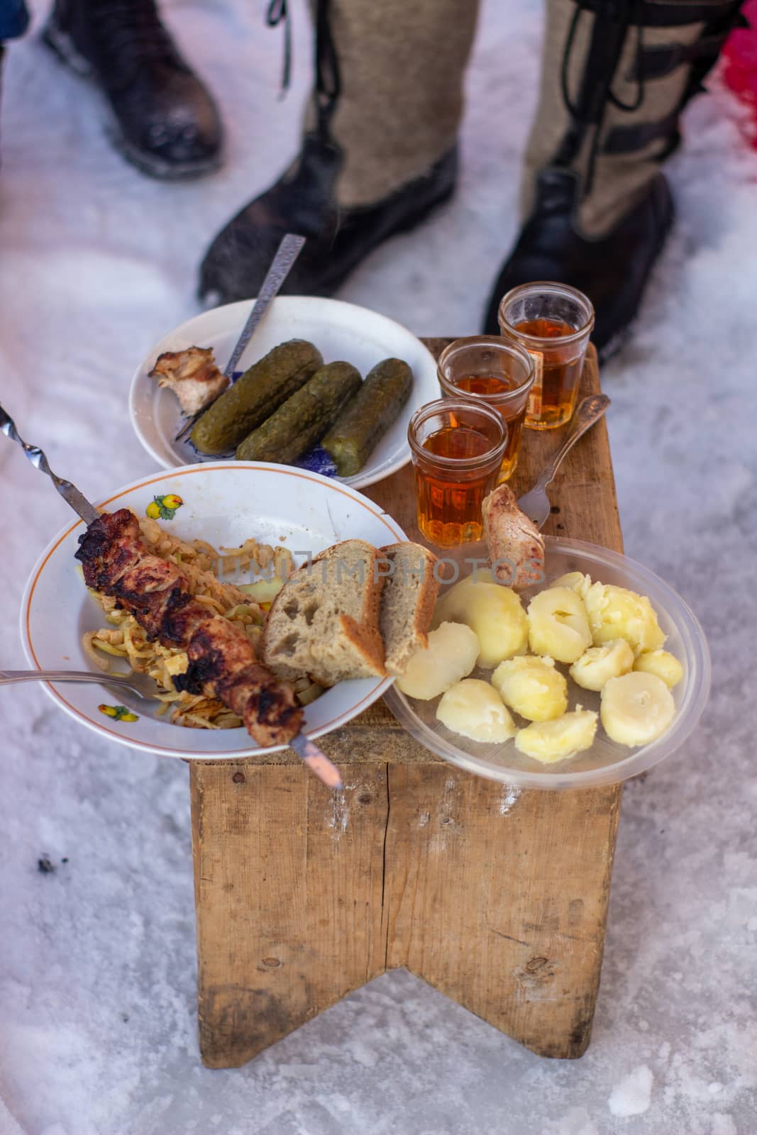 Alcohol and snacks in nature in winter. Winter in Siberia