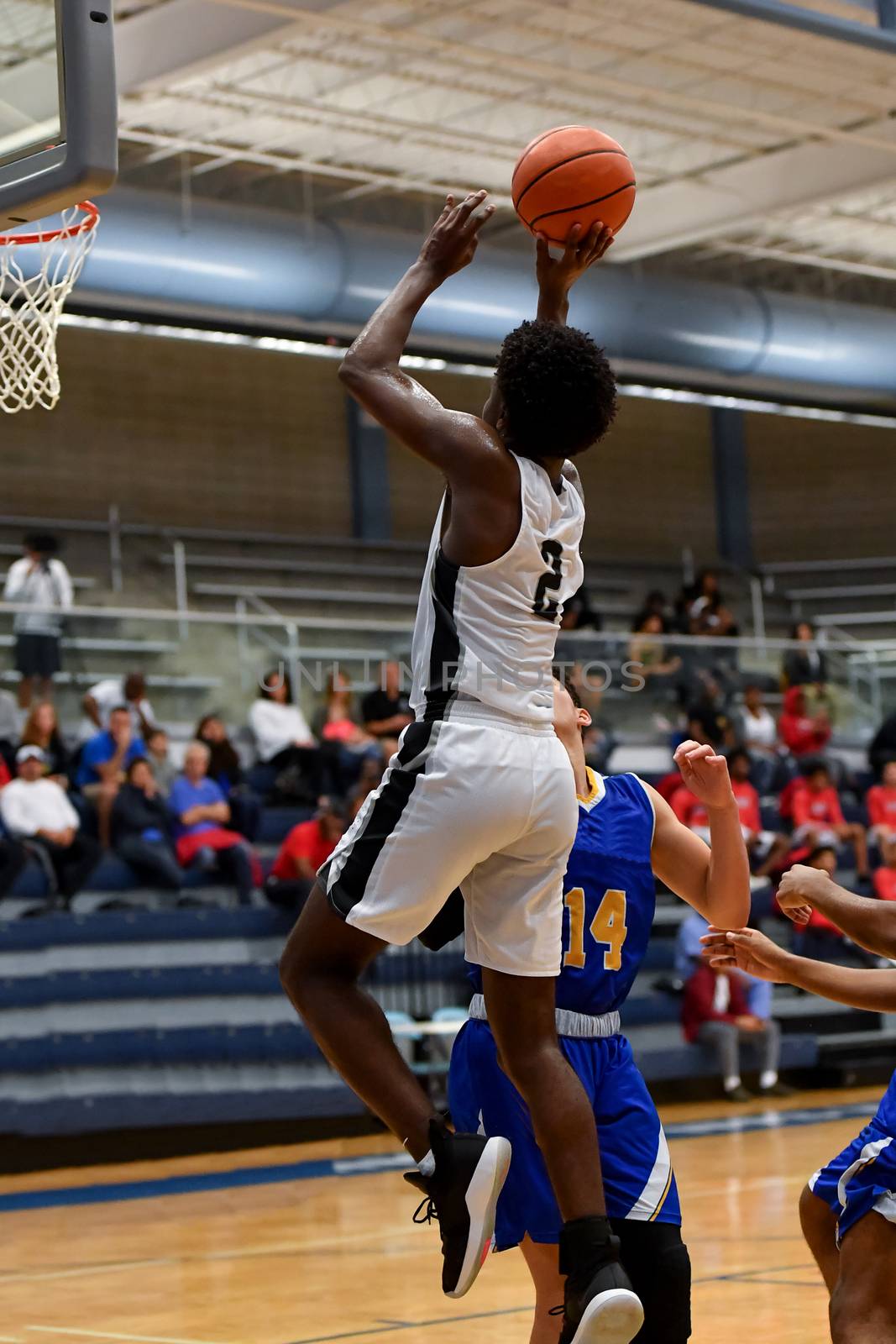 Young athletes making great basketball plays during a game. Slam Dunks and layups