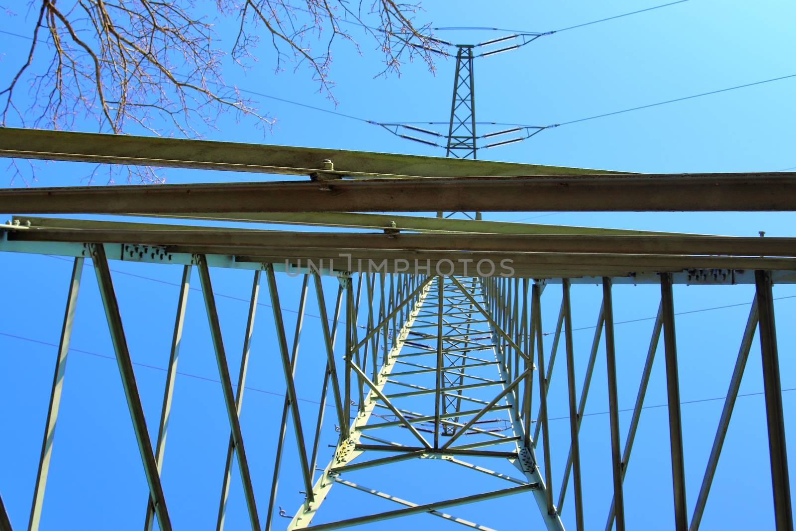 Close up view on a big power pylon transporting electricity in a countryside area in Europe