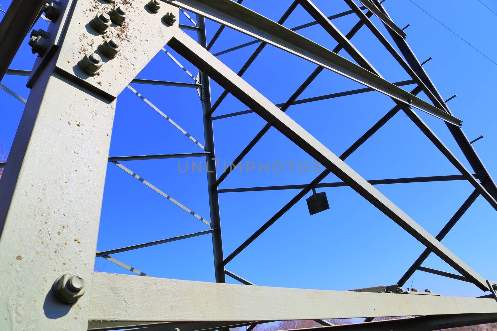 Close up view on a big power pylon transporting electricity in a countryside area in Europe