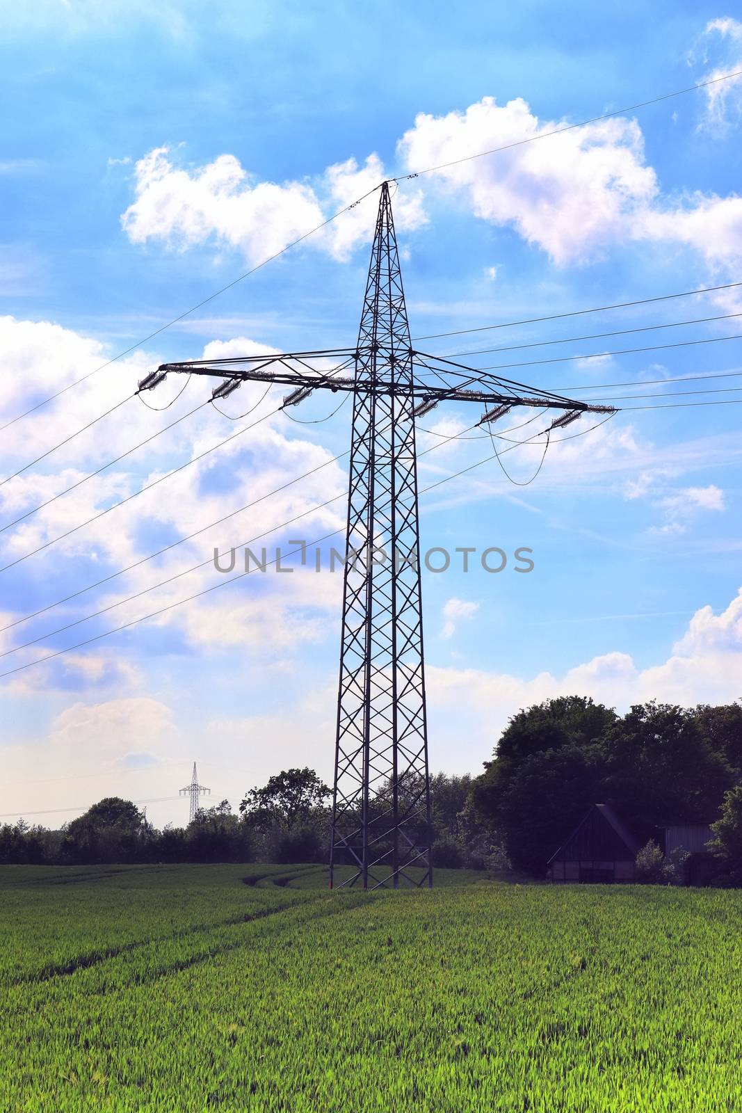 Close up view on a big power pylon transporting electricity in a countryside area in Europe