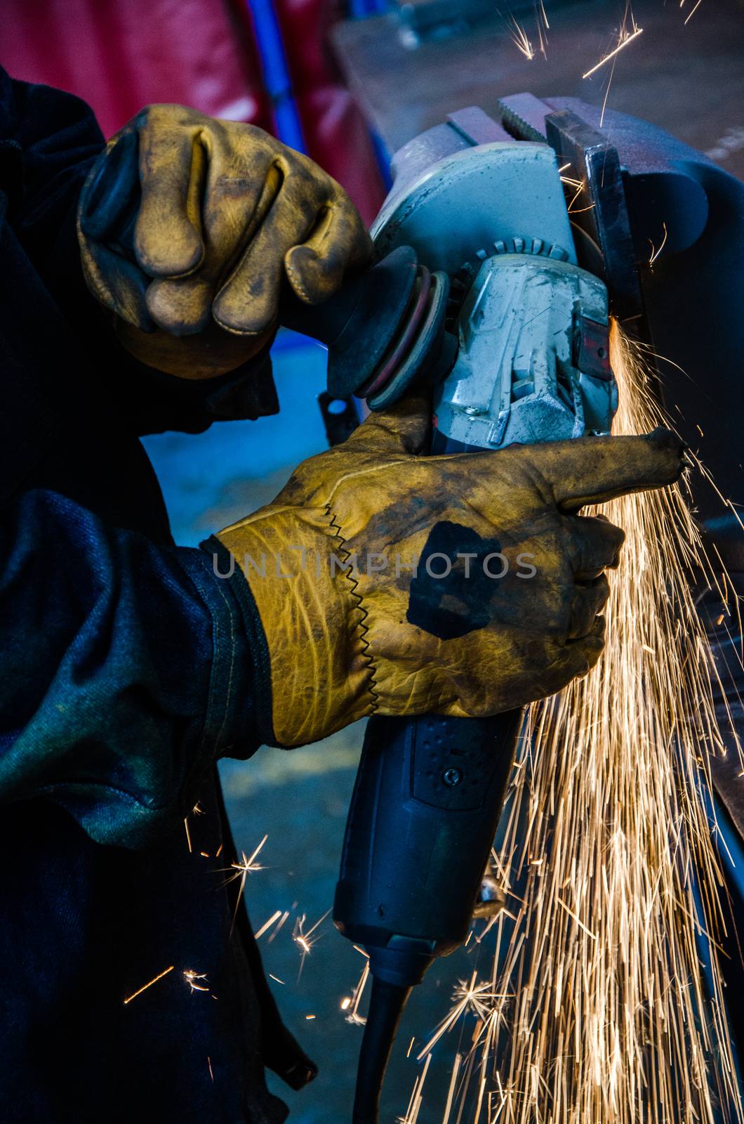 worker cutting iron with his tool