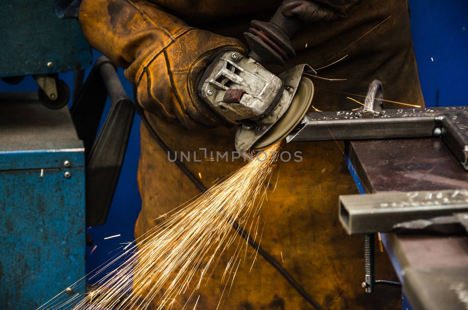 worker cutting iron with his tool