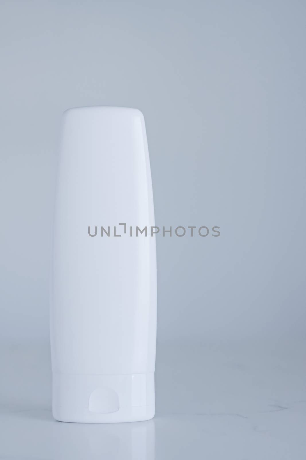 Blank label cosmetic container bottle as product mockup on gray background, hygiene and healthcare