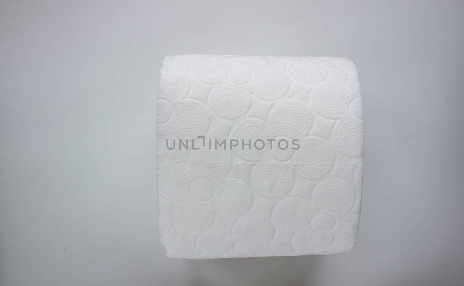 A roll of toilet paper on white background by AnatoliiFoto