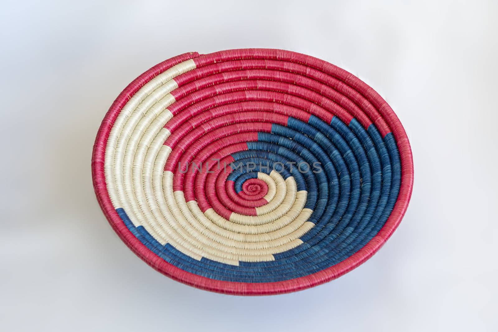 Red and blue wicker basket to arrange fruits and vegetables on a table.