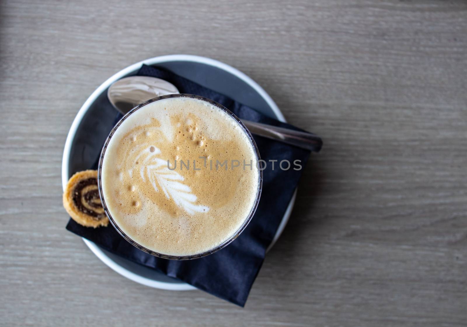 cappuccino cup on the brown wooden table