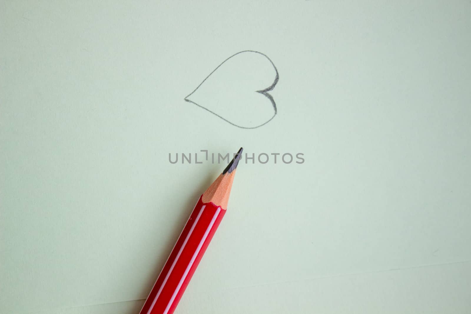 Heart drawn in pencil on a paper sheet, Close-up by AnatoliiFoto
