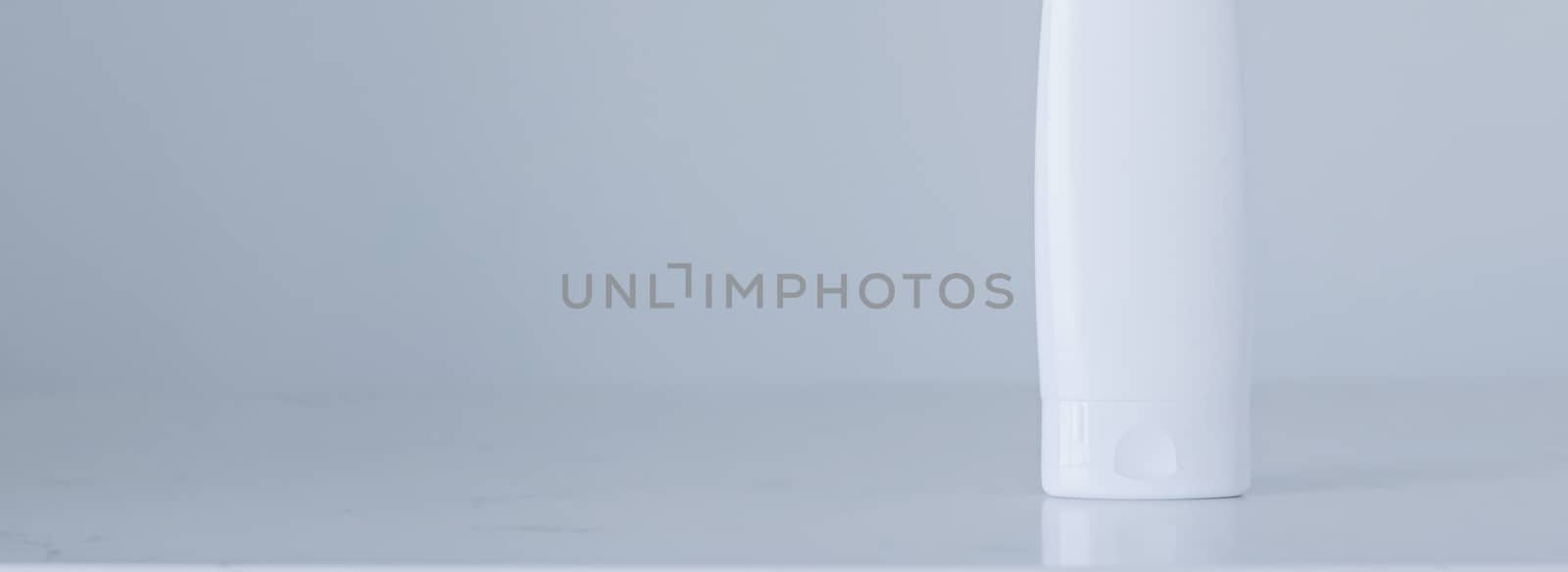 Blank label cosmetic container bottle as product mockup on gray background, hygiene and healthcare